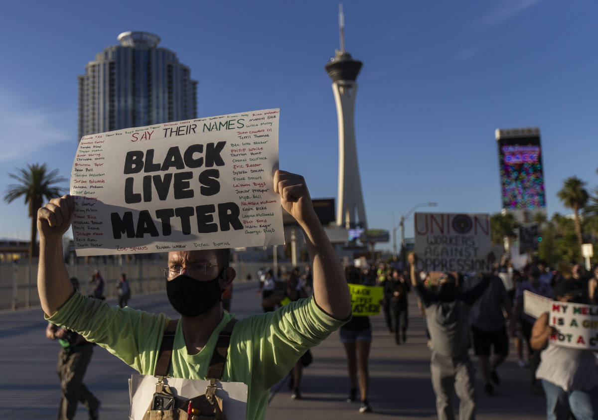 Protesters march south on the Strip during a Juneteenth rally organized by Black Lives Matter o ...