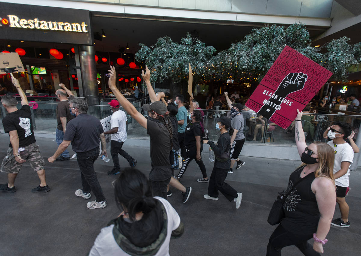 Protesters march south on the Strip during a Juneteenth rally organized by Black Lives Matter o ...