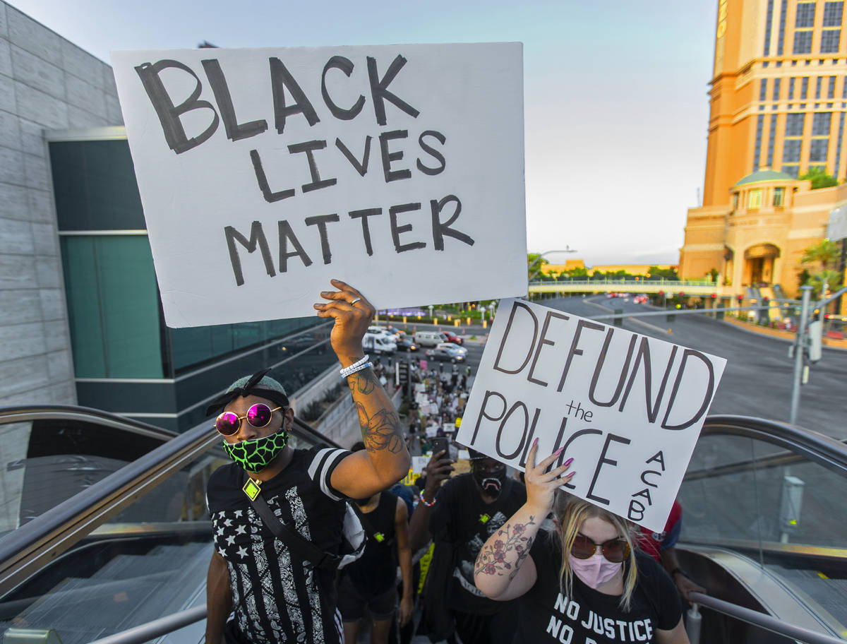 Protesters march south on the Strip during a Juneteenth rally organized by Black Lives Matter o ...