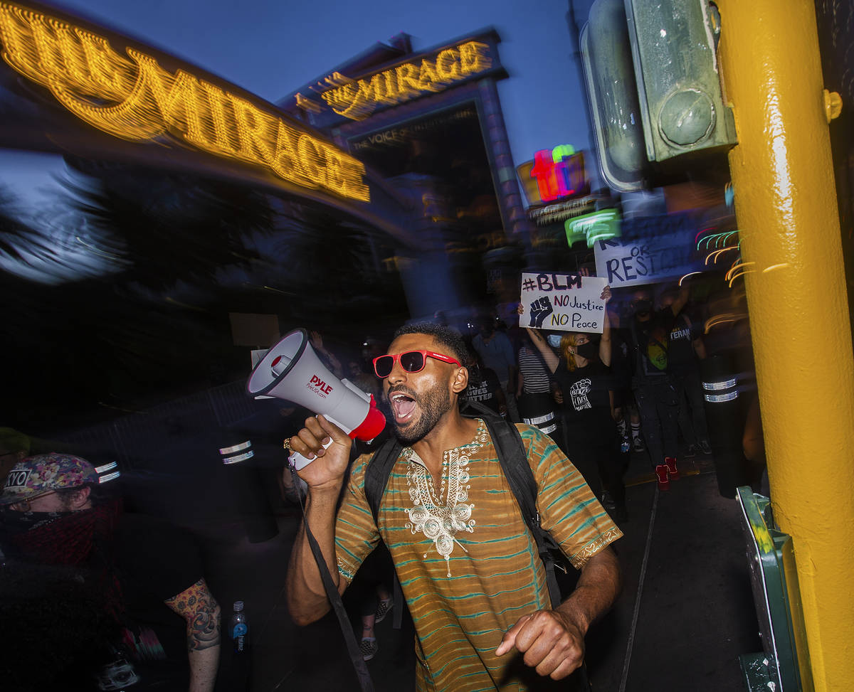 Protesters march south on the Strip during a Juneteenth rally organized by Black Lives Matter o ...
