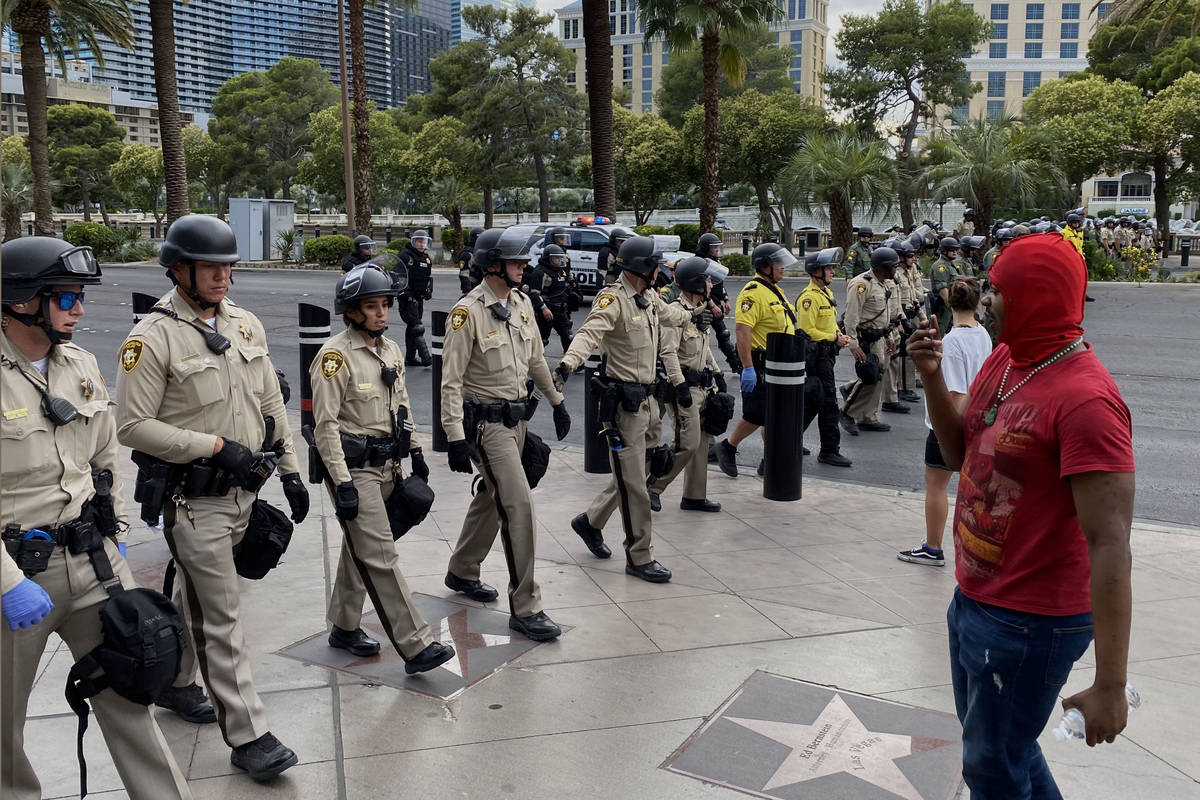 Las Vegas police officers form a line to block Las Vegas Boulevard, Friday, May 29, 2020, durin ...