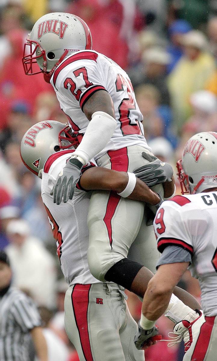 UNLV's Jamaal Brimmer (27) leaps into the arms of teammate Will Togoai after running back a fum ...