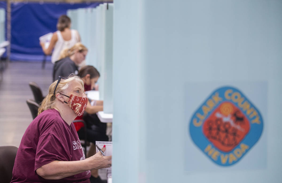 Voters fill out their ballots during the state’s first all-mail primary at the Clark Cou ...