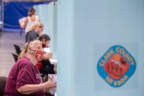 Voters fill out their ballots during the state’s first all-mail primary at the Clark Cou ...