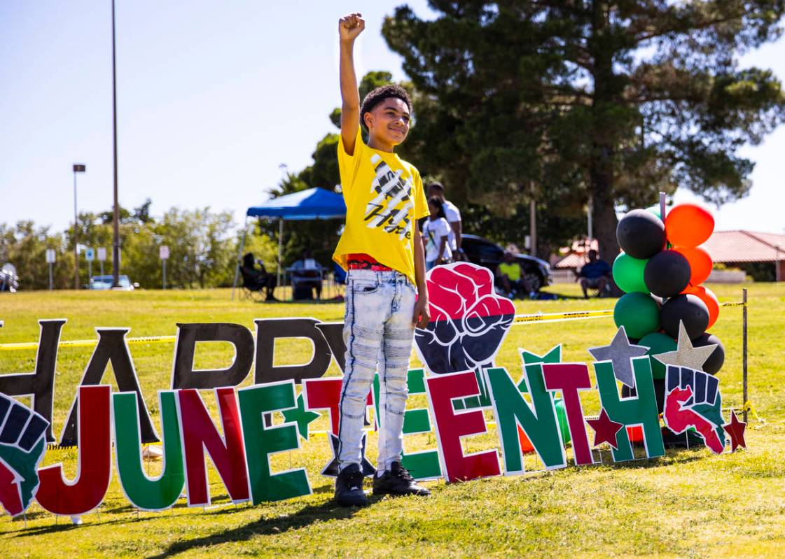 Malachi Smith, 13, of Las Vegas, raises his fist while posing for a picture during a Juneteenth ...