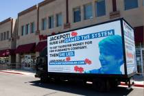 A mobile billboard attacking Rep. Susie Lee drives in front of Lee's office in Las Vegas on Thu ...