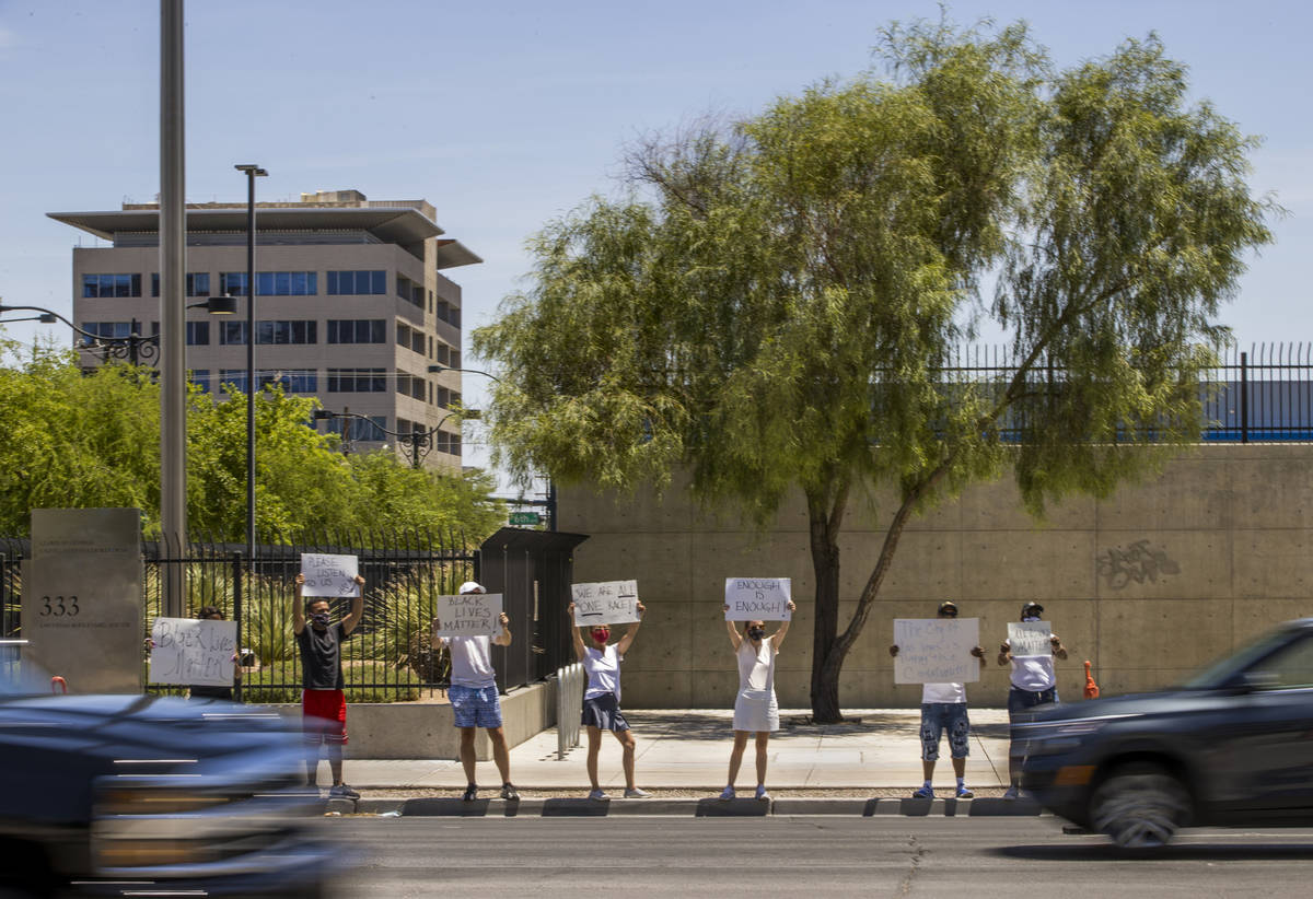 A small group gathers with signs as part of a Black Lives Matter rally outside the Foley Federa ...