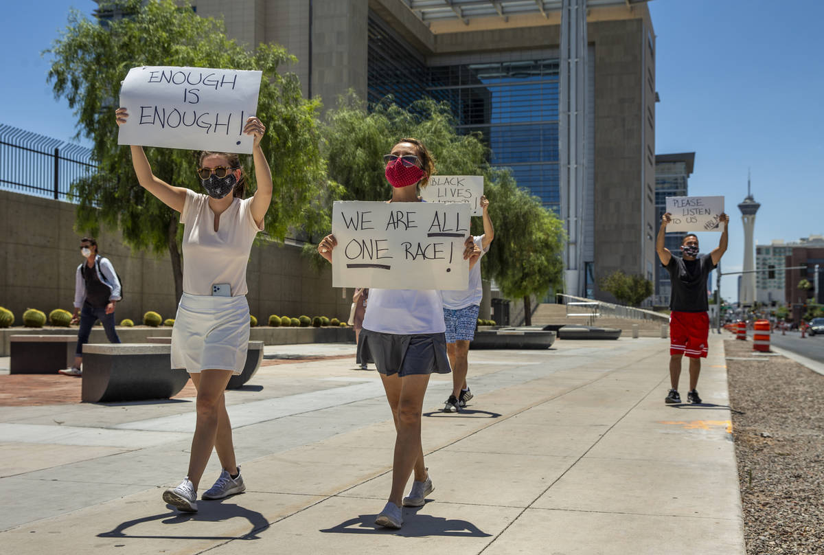 A small group walks with signs as part of a Black Lives Matter rally outside the Foley Federal ...