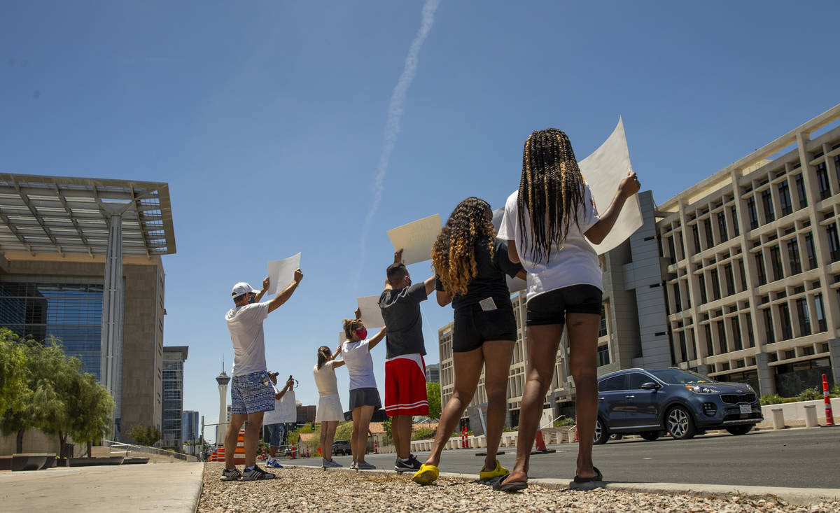 A small group stands with signs as part of a Black Lives Matter rally outside the Foley Federal ...
