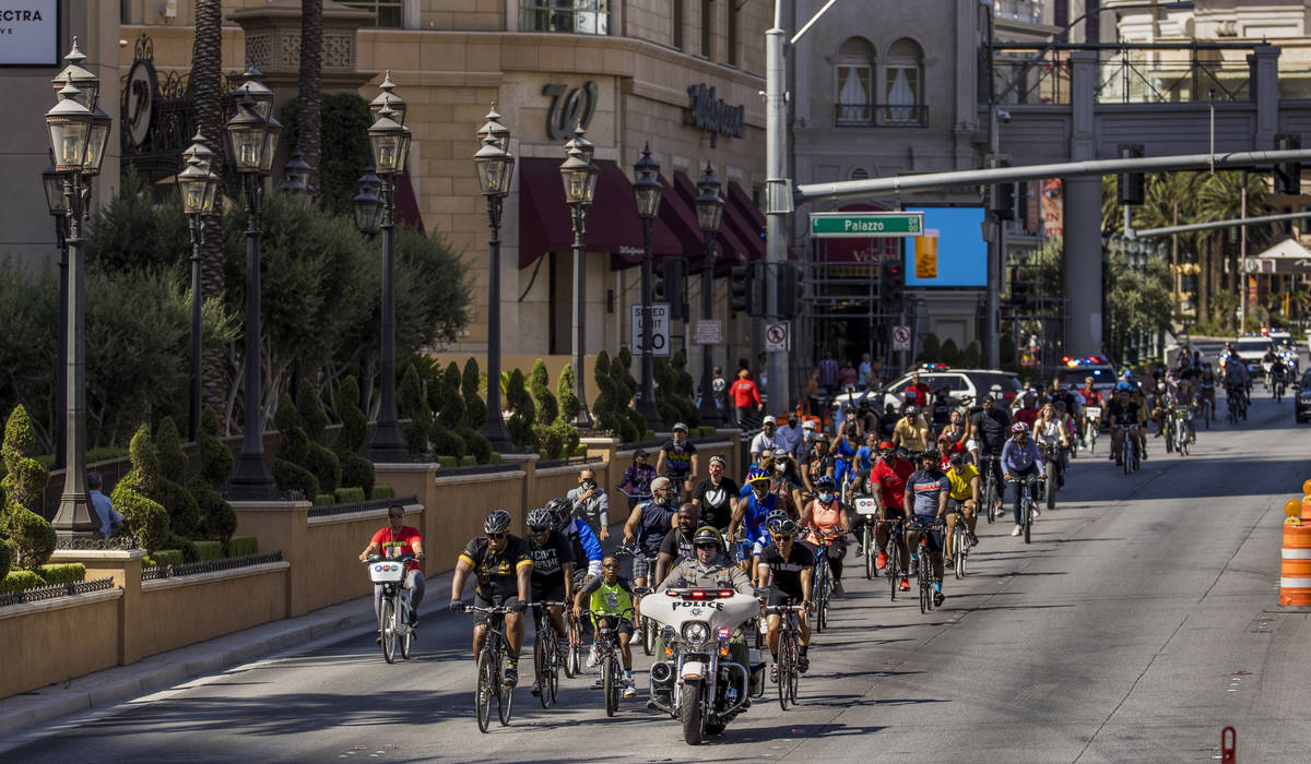 Participants in a Black Lives Matter bike ride against injustice pass The Palazzo while heading ...