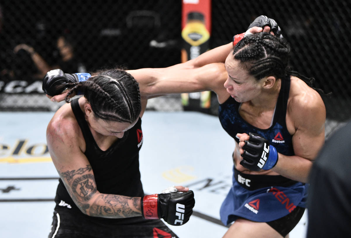 LAS VEGAS, NEVADA - JUNE 20: (R-L) Marion Reneau and Raquel Pennington trade punches in their b ...
