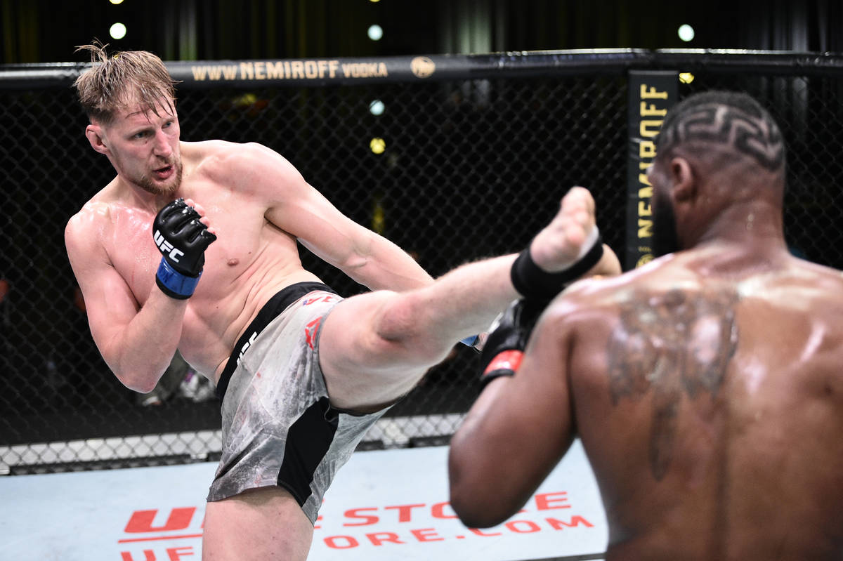 LAS VEGAS, NEVADA - JUNE 20: (L-R) Alexander Volkov of Russia kicks Curtis Blaydes in their hea ...