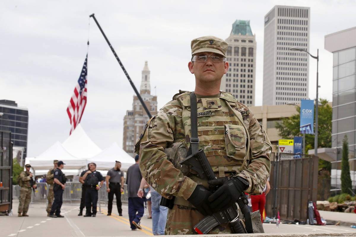 The National guard stands outside the BOK Center where President Trump will hold a rally in Tul ...