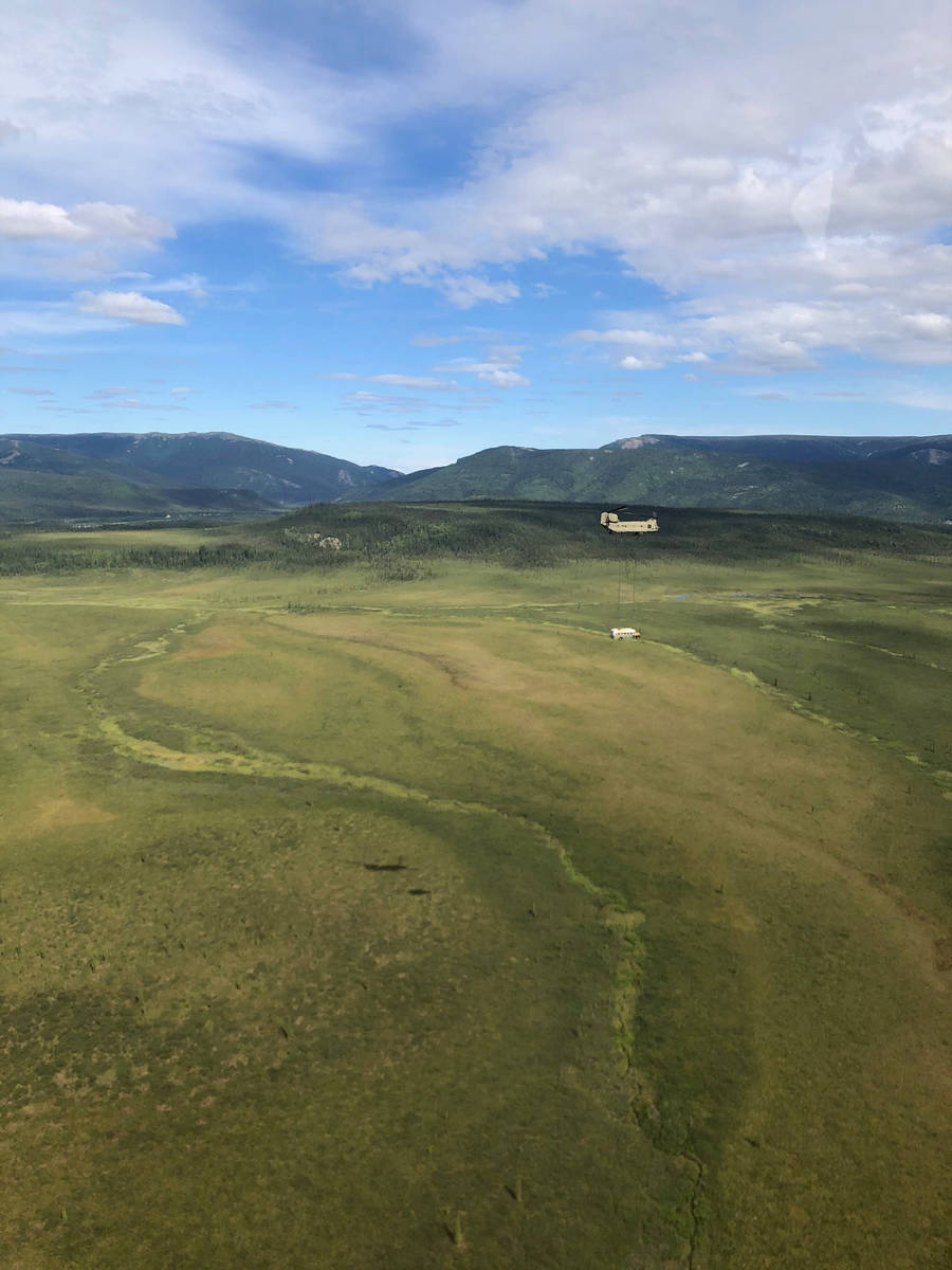 In this photo released by the Alaska National Guard, Alaska Army National Guard soldiers use a ...