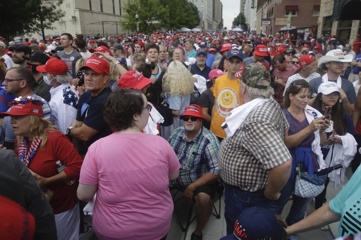 People wait in downtown Tulsa, Okla., to enter President Donald Trump's campaign rally on Satur ...
