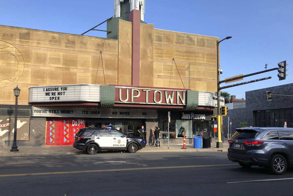 A police vehicle is parked outside the Uptown Theatre Sunday, June 21, 2020, following a shooti ...