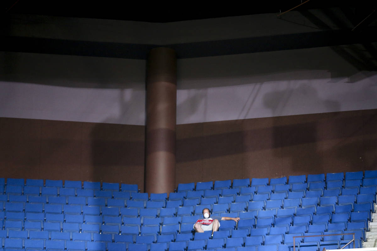 An attendee sits and listens to President Donald Trump speak during his campaign rally at BOK C ...