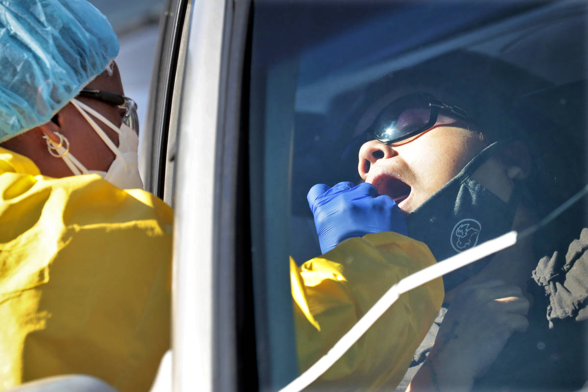 People get tested for COVID-19 at a drive through testing site hosted by the Puente Movement mi ...