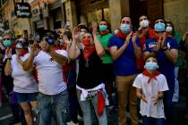 FILE In this Saturday, June 20, 2020 file photo, residents wear faces mask to protect against c ...