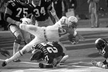 Miami Dolphins Jim Kiick goes headfirst over Pittsburgh Steelers" Glen Edwards as Kiick scores ...