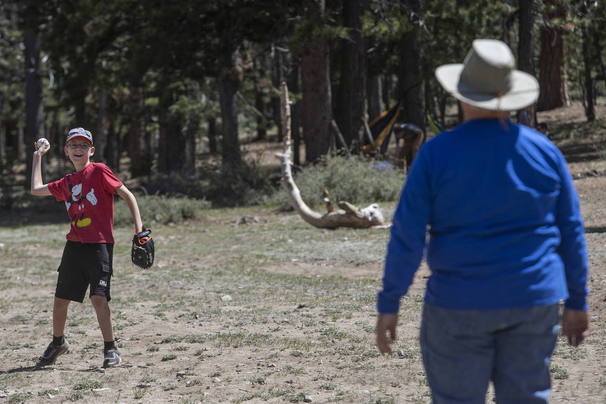 Landon Whitehead, 12, plays catch with his grandfather, Doug Whitehead, 61, at Lee Canyon on Mo ...