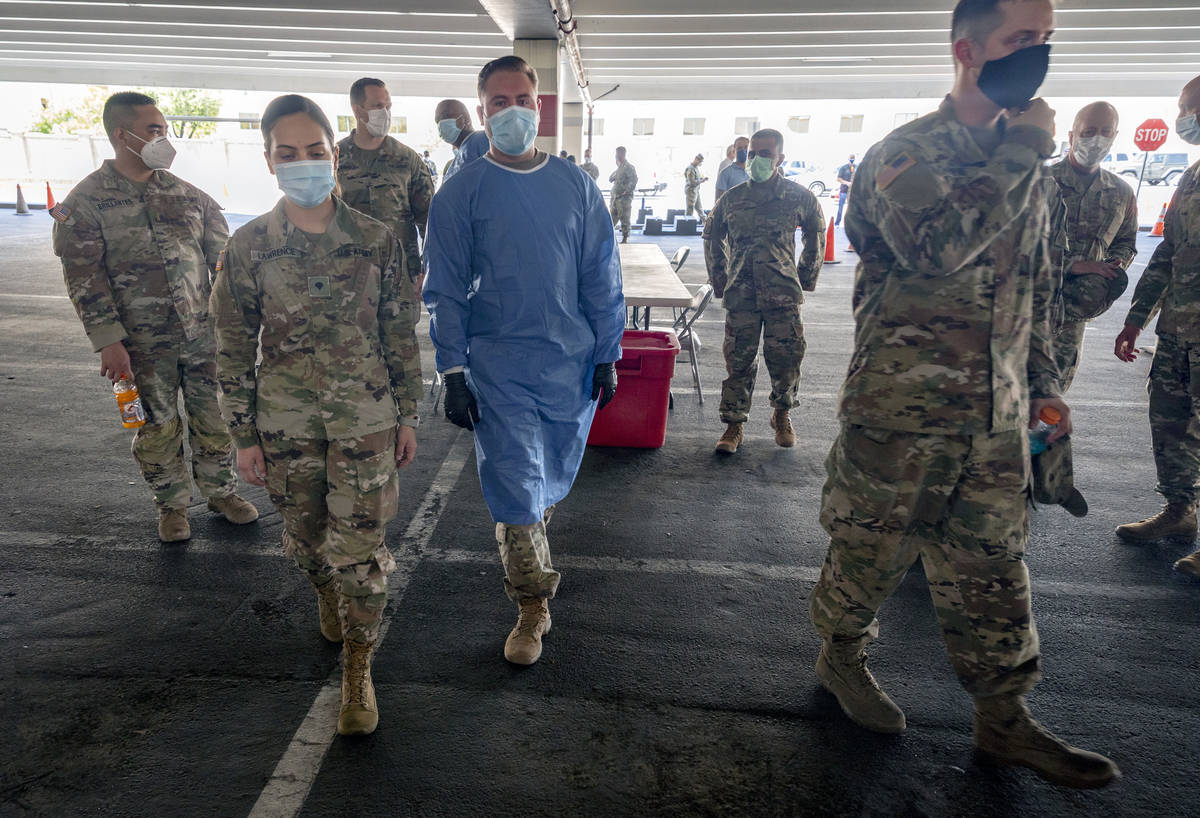 Nevada National Guardsmen take part in a preview of the new drive-thru COVID-19 testing site in ...