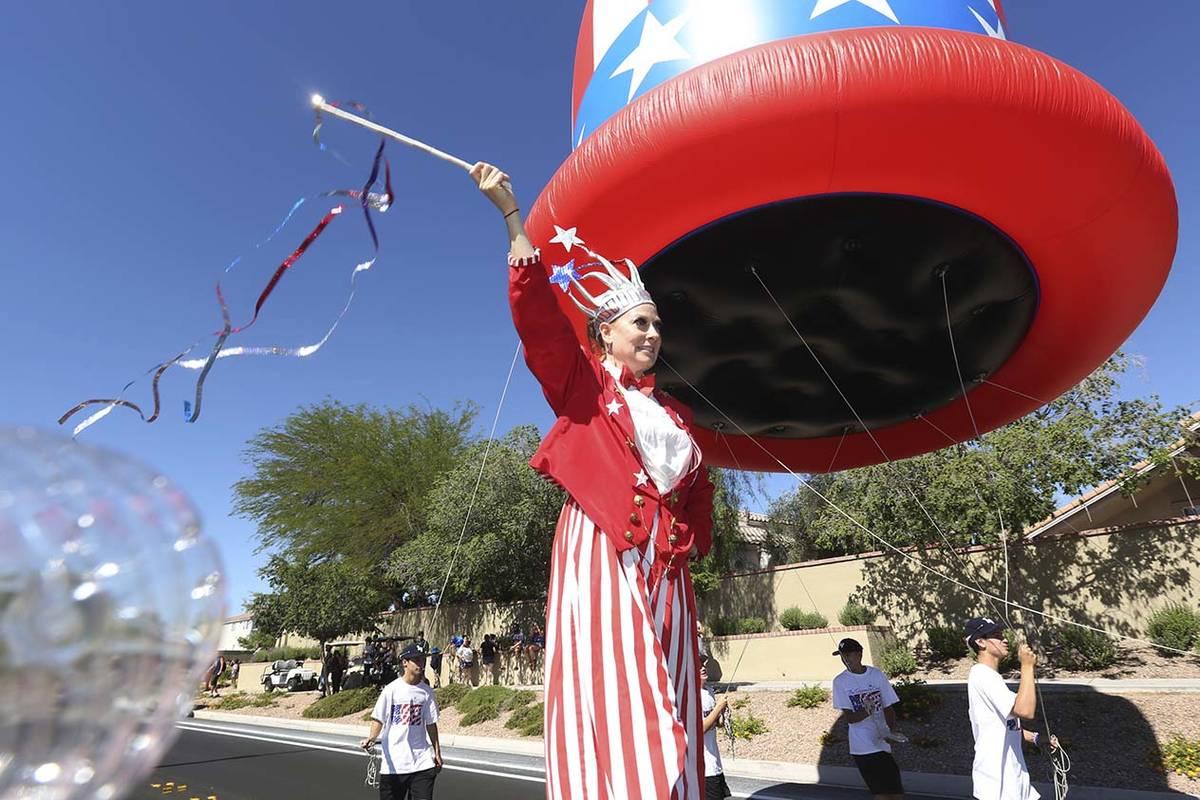 Sara Back waves her baton during the 25th annual Summerlin Council Patriotic Parade on July 4, ...