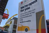 FILE - In this May 20, 2020 file photo, a sign posted outside a McDonald's restaurant reads: "W ...