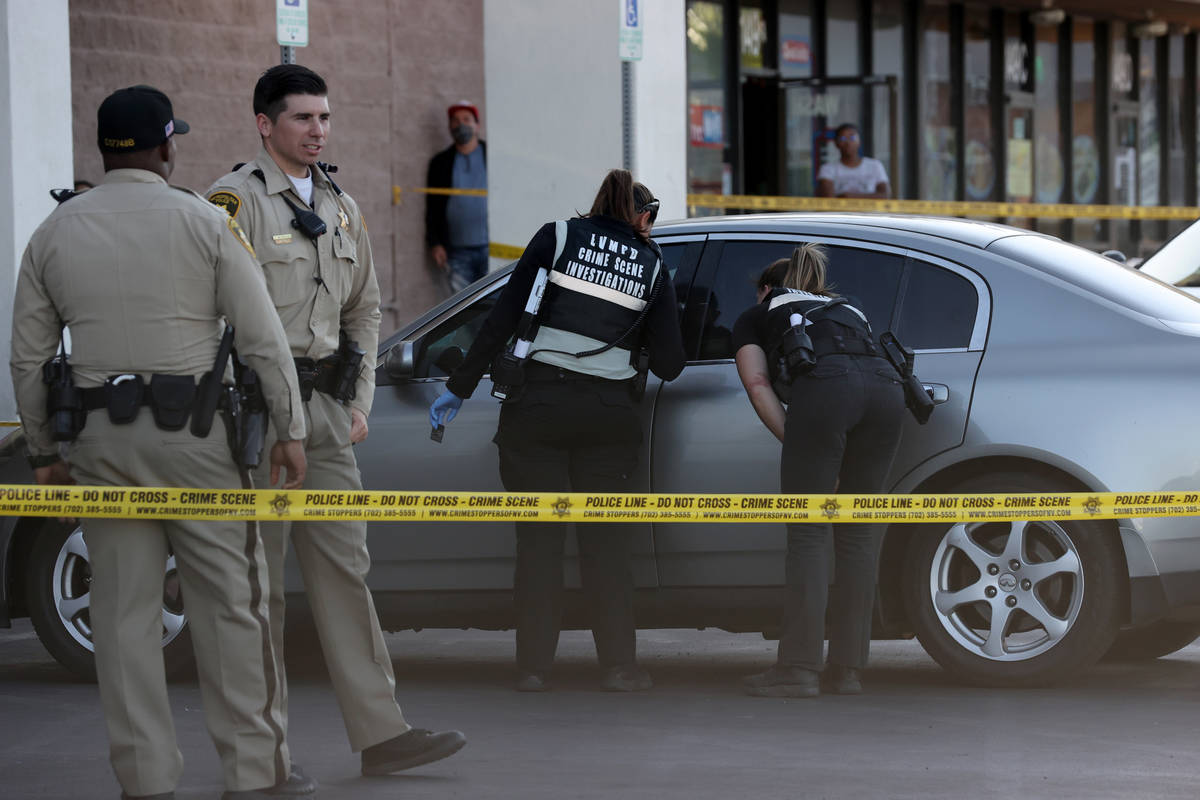Las Vegas police investigate a shooting at the 99 Cents Only Store on North Rancho Drive at Che ...