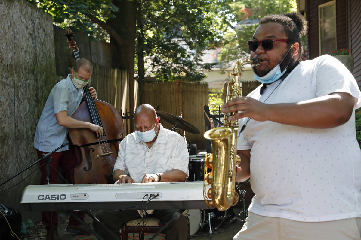 Elijah Herring, right, plays the sax while performing with keyboardist Kenny Barron, center, an ...