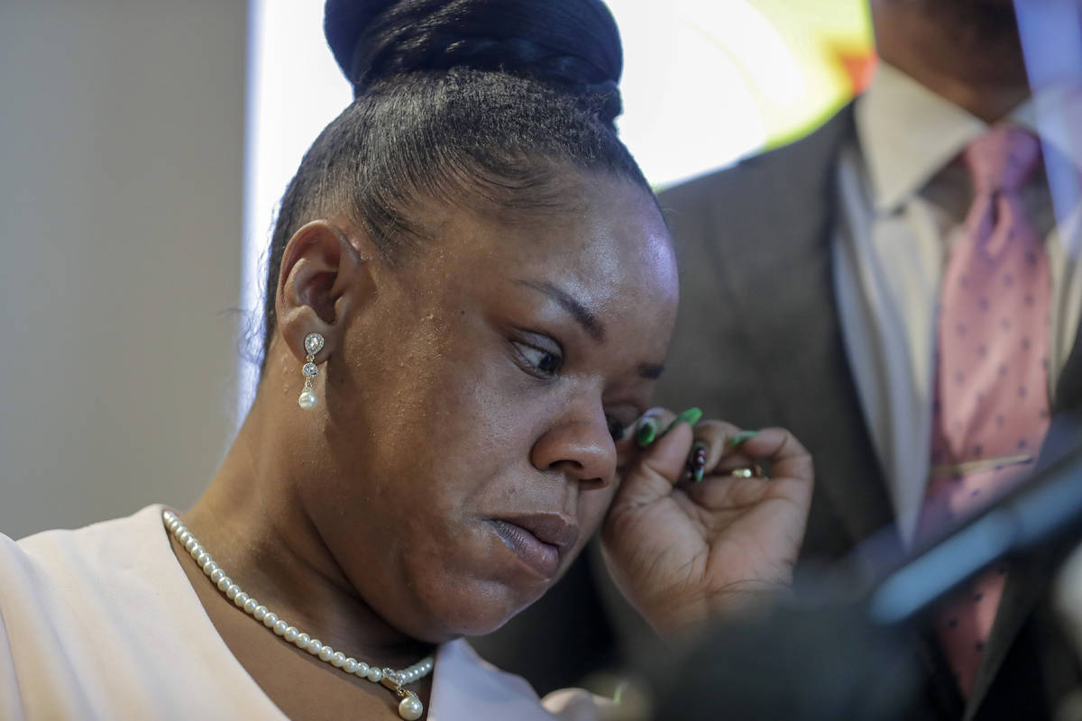 Tomika Miller, center, widow of Rayshard Brooks wipes a tear away during a news conference, Wed ...