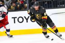 Golden Knights' Nate Schmidt (88) skates with the puck in front of Columbus Blue Jackets' Emil ...