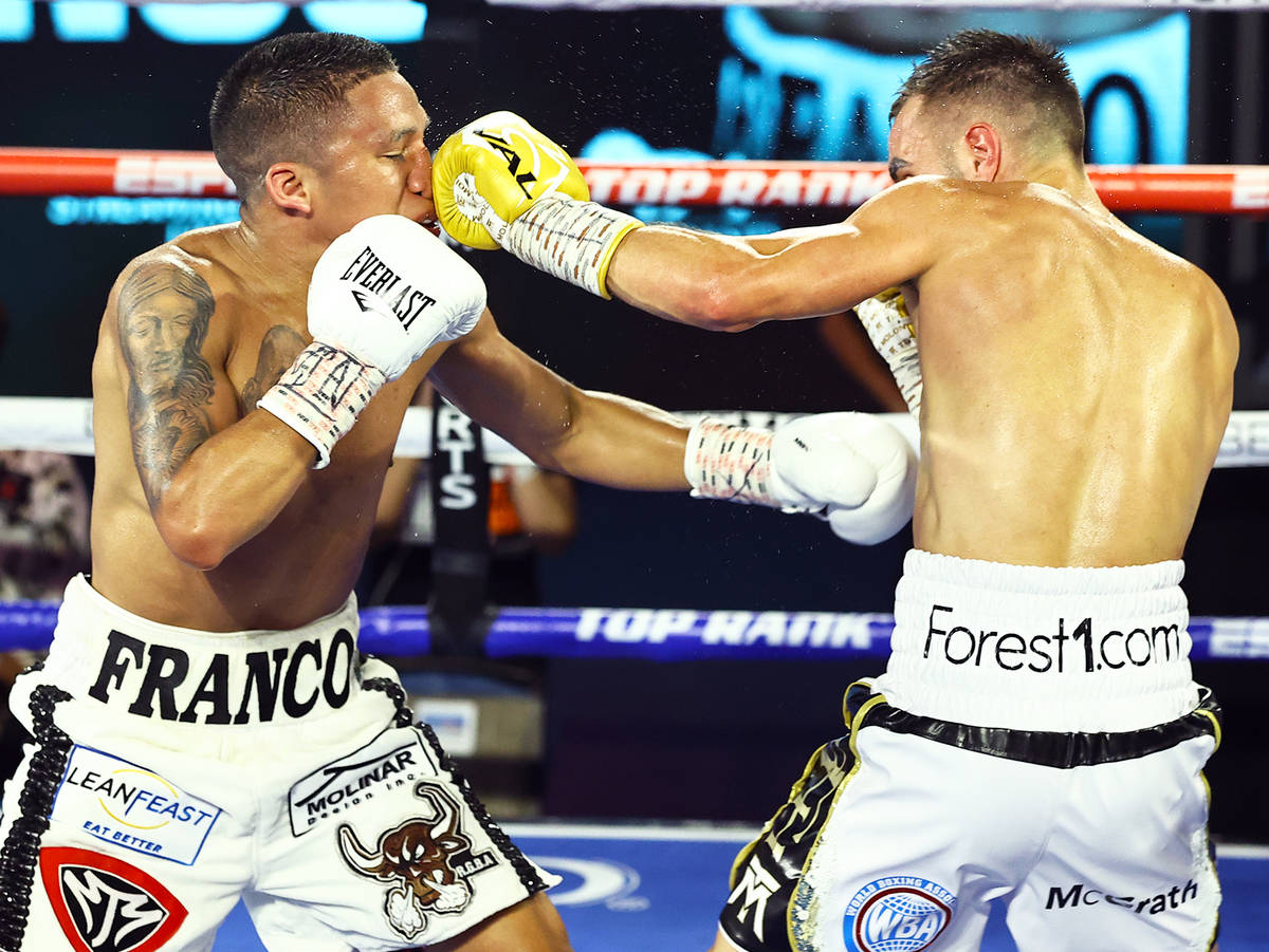 Joshua Franco, left, and Andrew Moloney trade punches Tuesday, June 23, 2020, at the MGM Grand ...
