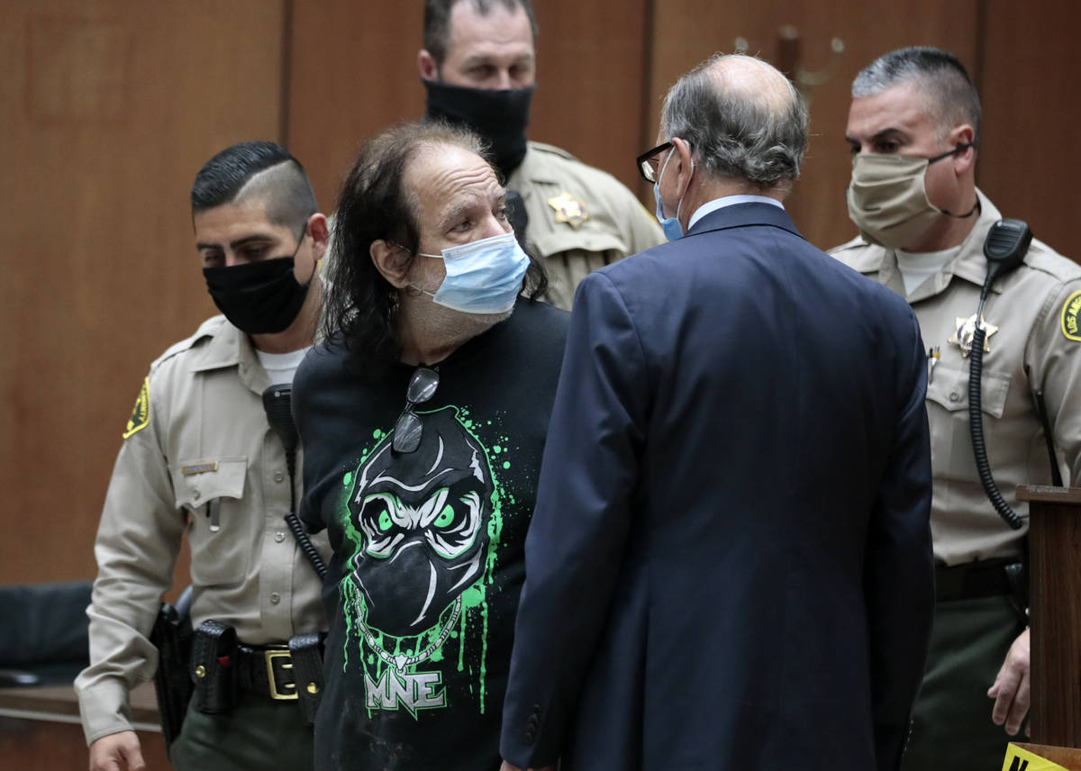 Adult film star Ron Jeremy looks over to his attorney Stuart Goldfarb, right, during an appeara ...