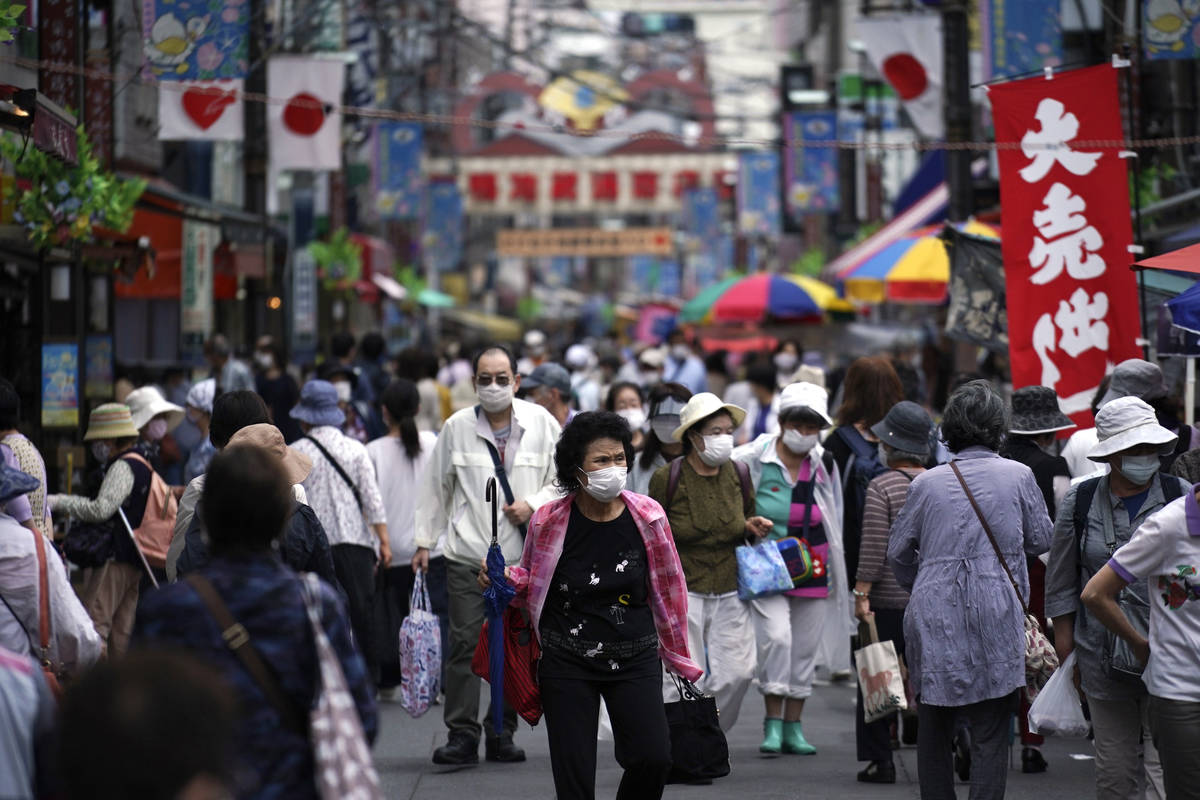 A street is crowded by shoppers in Tokyo Wednesday, June 24, 2020. Japan’s economy is op ...