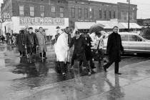 In a March 1, 1965, file photo Dr. Martin Luther King Jr. hops over a puddle as it rains in Sel ...
