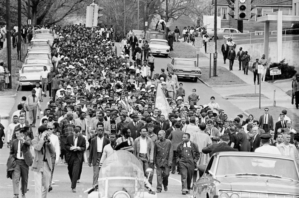 FILE - In this March 17, 1965, file photo, demonstrators walk to the courthouse behind the Rev. ...