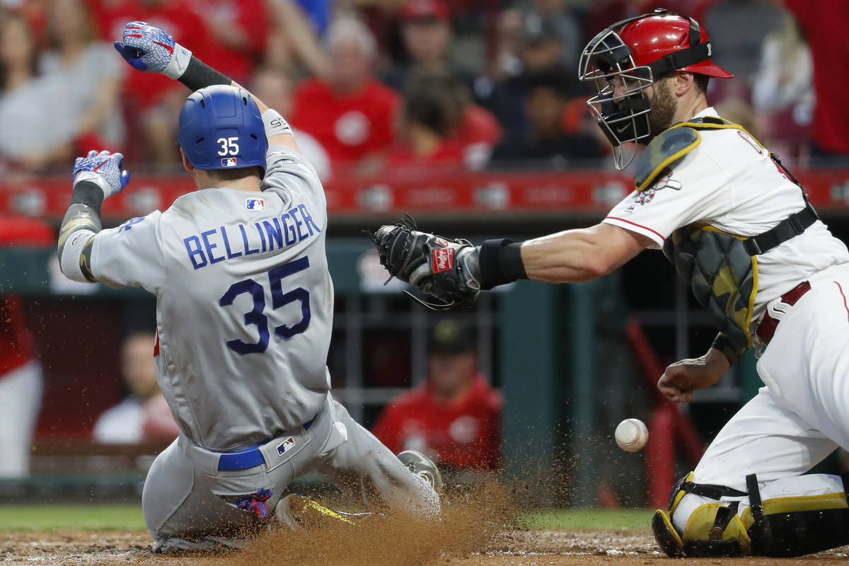 Los Angeles Dodgers' Cody Bellinger (35) scores against Cincinnati Reds catcher Curt Casali, ri ...