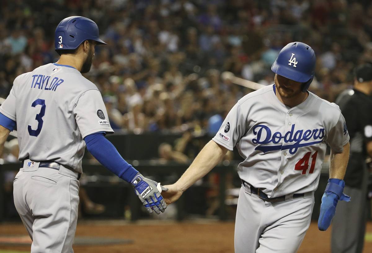 Los Angeles Dodgers' Kyle Garlick (41) slaps hands with Dodgers' Chris Taylor (3) after Garlick ...