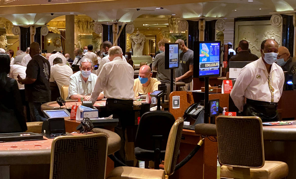 Gamblers don protective face masks at Caesars on the Strip in Las Vegas Wednesday, June 24, 202 ...