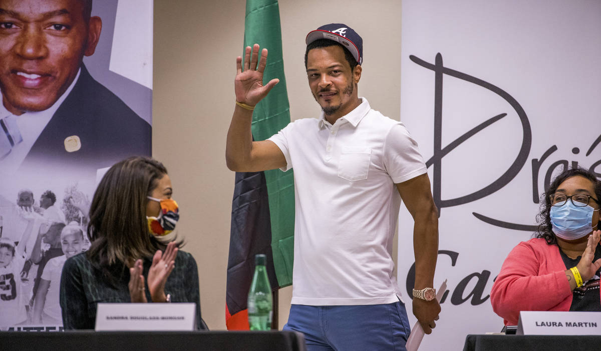 Rapper and entrepreneur Tip T.I. Harris, center, arrives to moderate a Solutions, Strategies &a ...
