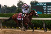 Jockey Manny Franco reacts after winning the 152nd running of the Belmont Stakes horse race ato ...