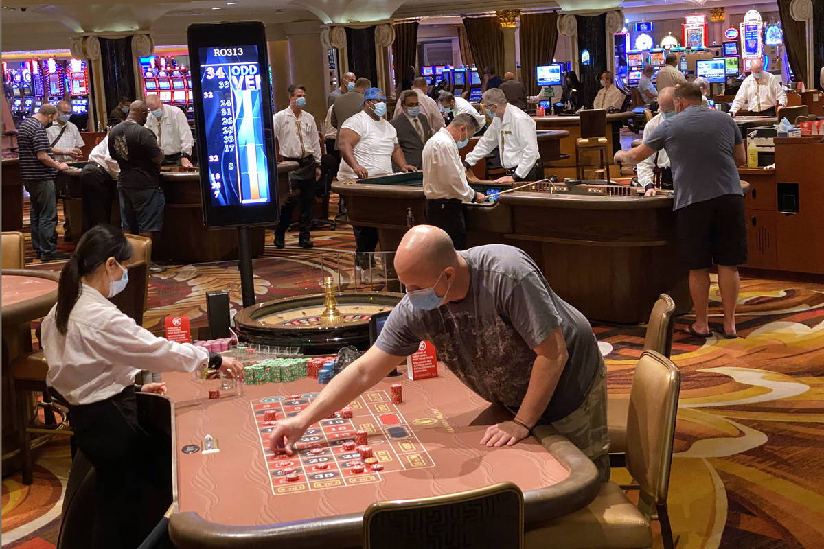 Gamblers don protective face masks at Caesars on the Strip in Las Vegas Wednesday, June 24, 202 ...