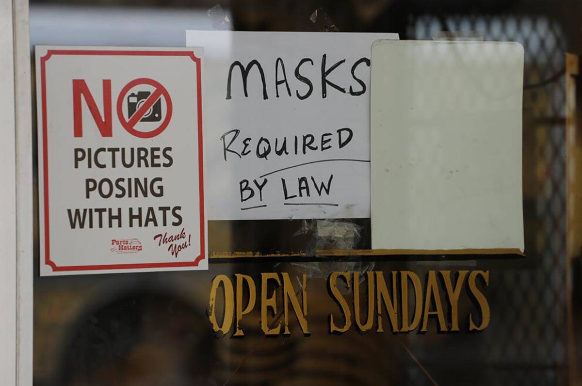 A sign instructing shoppers to wear masks to protect against the spread of COVID-19 is posted a ...