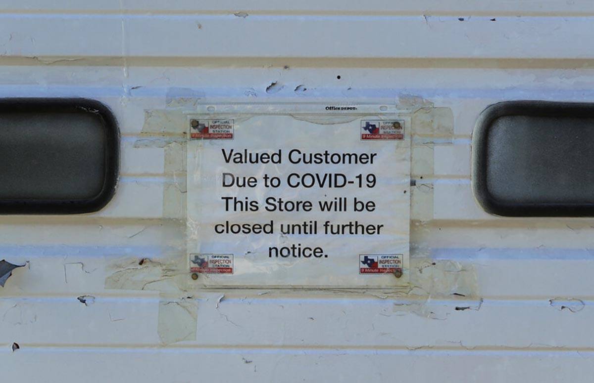 A sign for temporary closure due to COVID-19 is displayed on a business, in San Antonio, Thursd ...