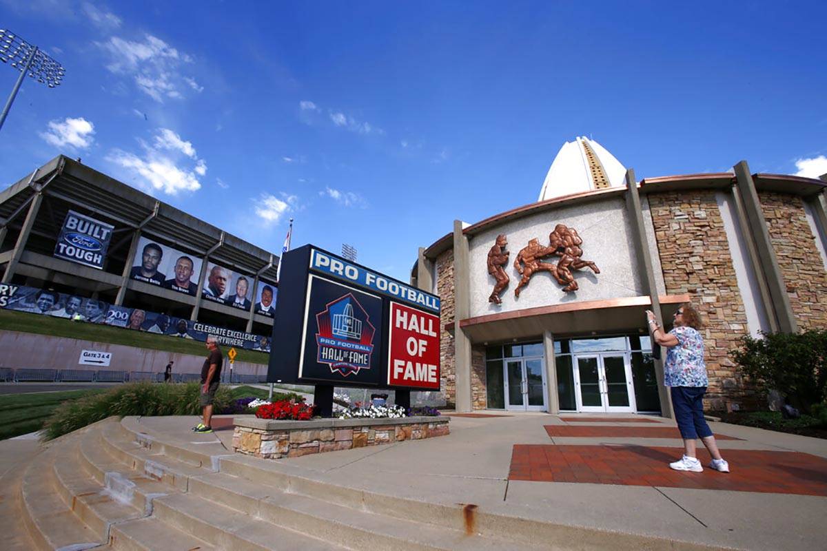 In this Aug. 7, 2015, file photo, a visitor to the Pro Football Hall of Fame pauses to take a p ...