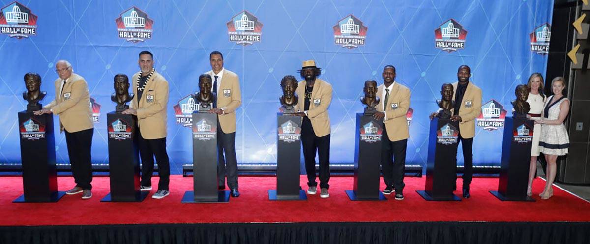 FILE - In this Aug. 4, 2019, file photo, NFL inductees and family members pose with busts durin ...