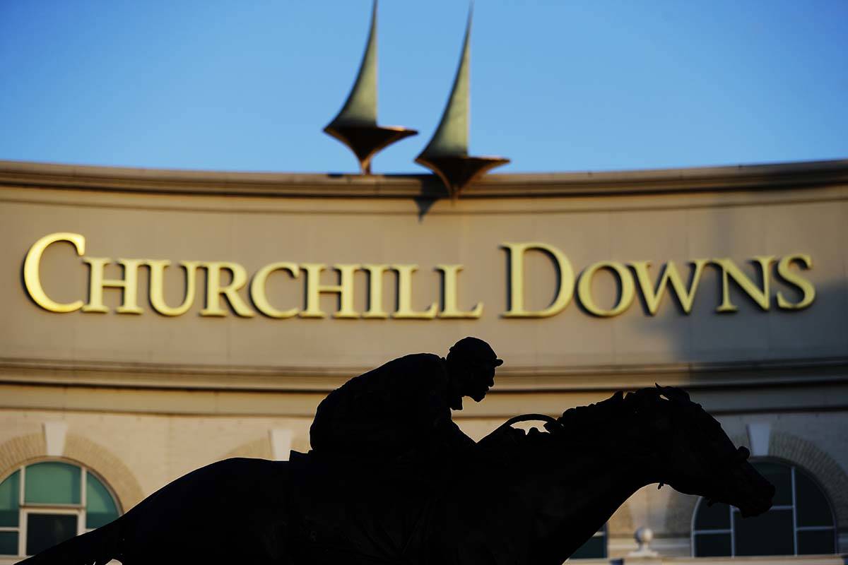 A statue of Barbaro is silhouetted at the entrance of Churchill Downs, Wednesday, May 6, 2020, ...