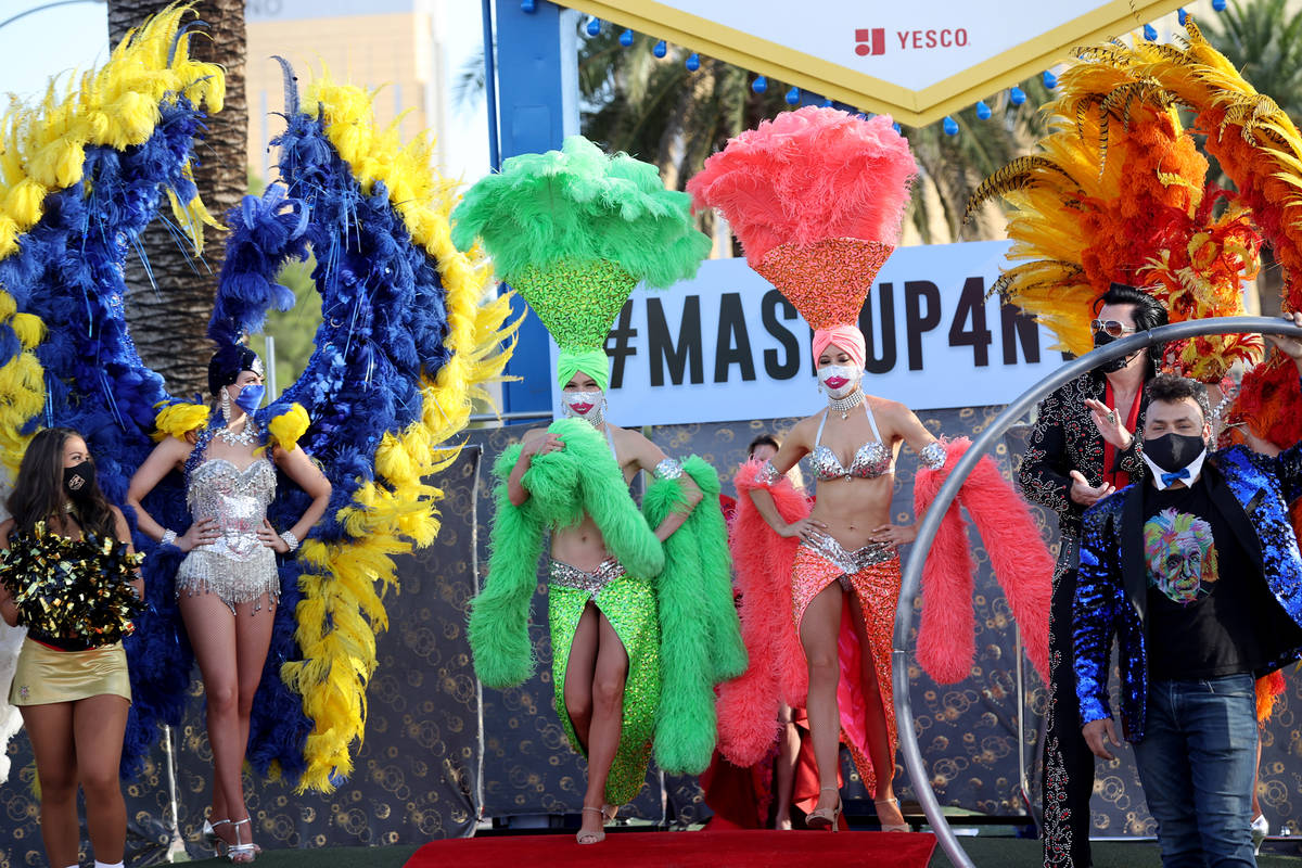Showgirls walk the red carpet at the Welcome to Fabulous Las Vegas sign on the south Strip in L ...