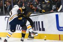 Buffalo Sabres' Henri Jokiharju (10) battles for the puck against Golden Knights' Chandler Step ...